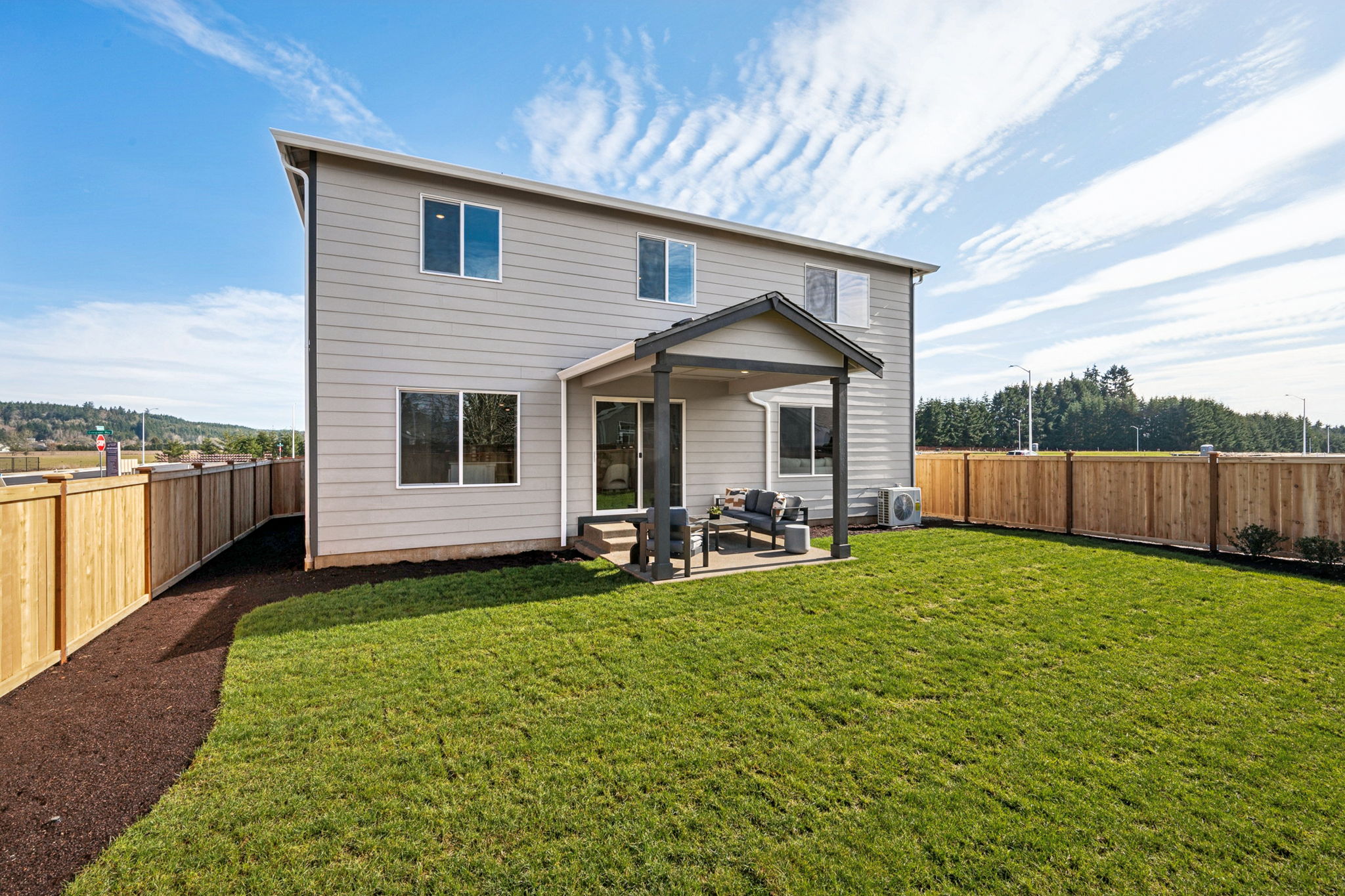 A house with a fence and grass.