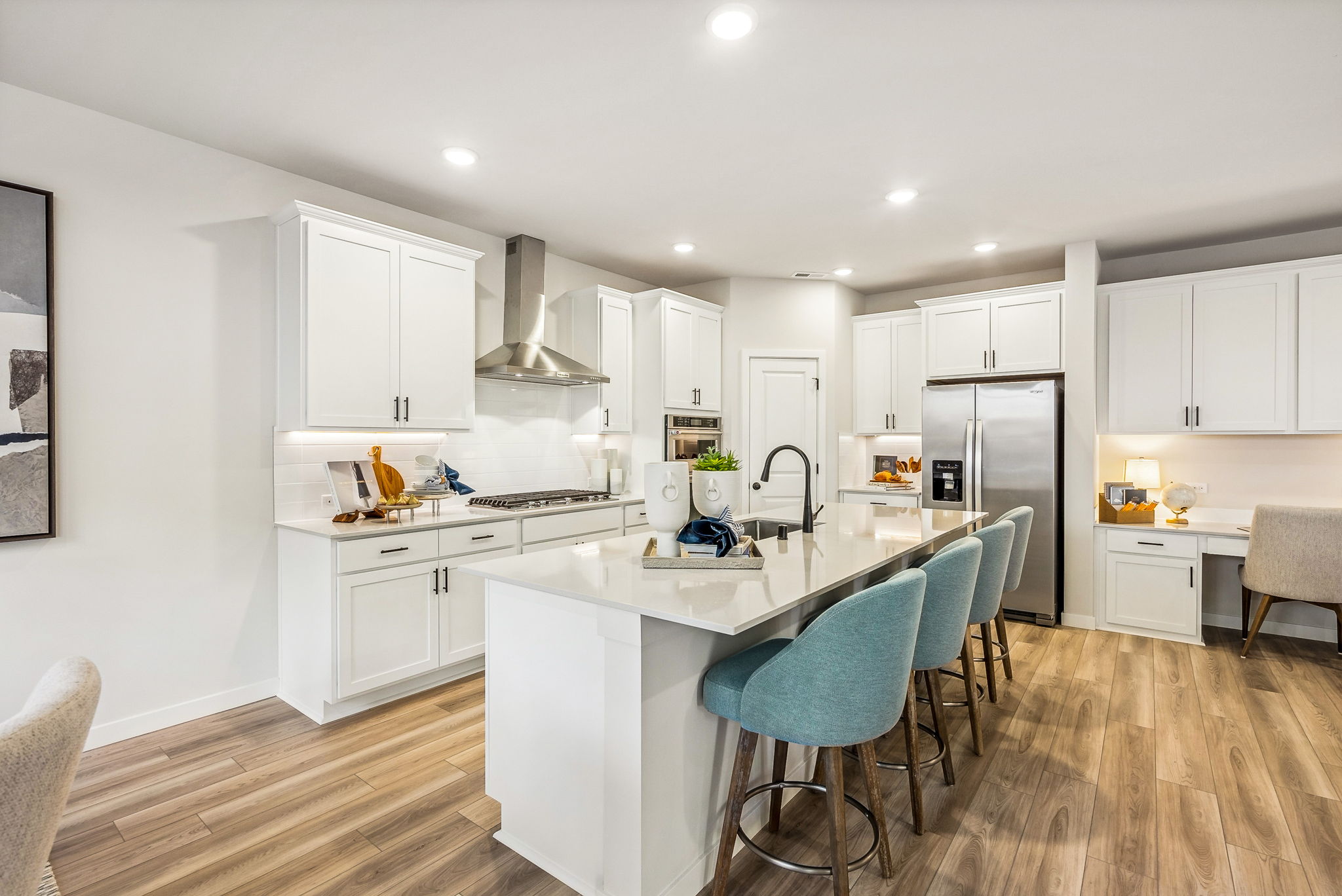 A kitchen with white cabinets.