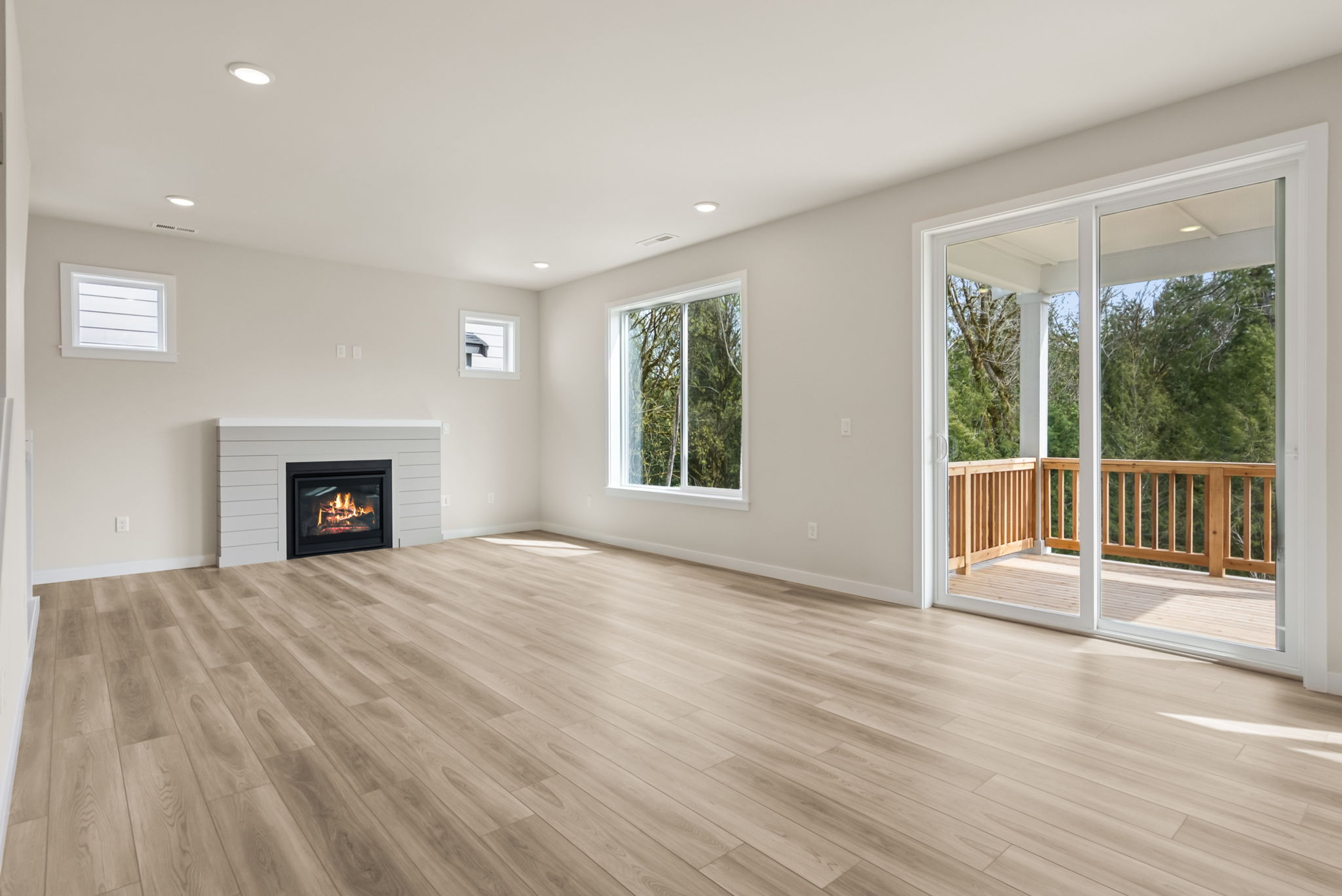 A room with a fireplace and a wood floor.