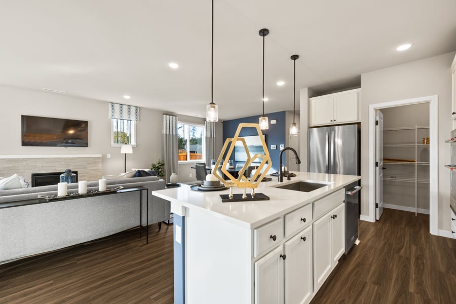 A kitchen with white cabinets.
