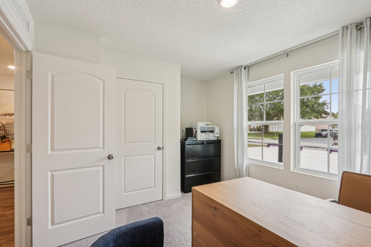A kitchen with white cabinets.