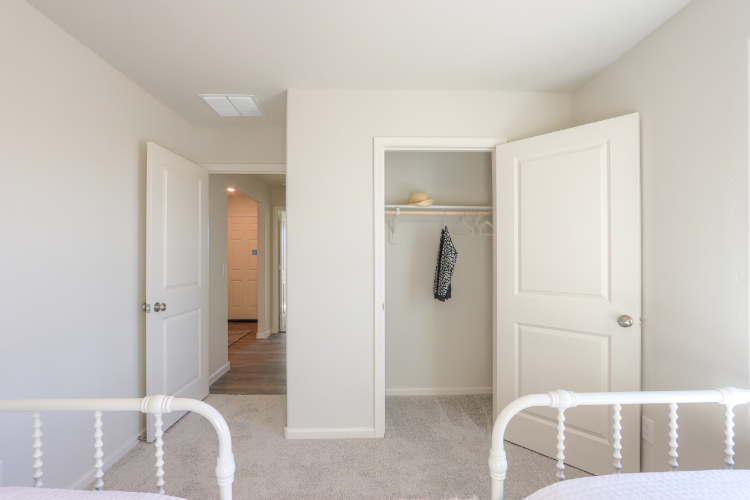 A room with white walls and a white bed.