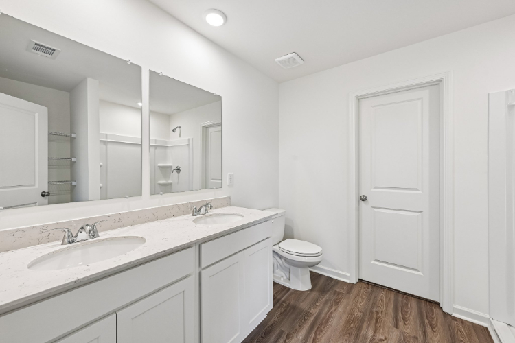 A bathroom with a large mirror.