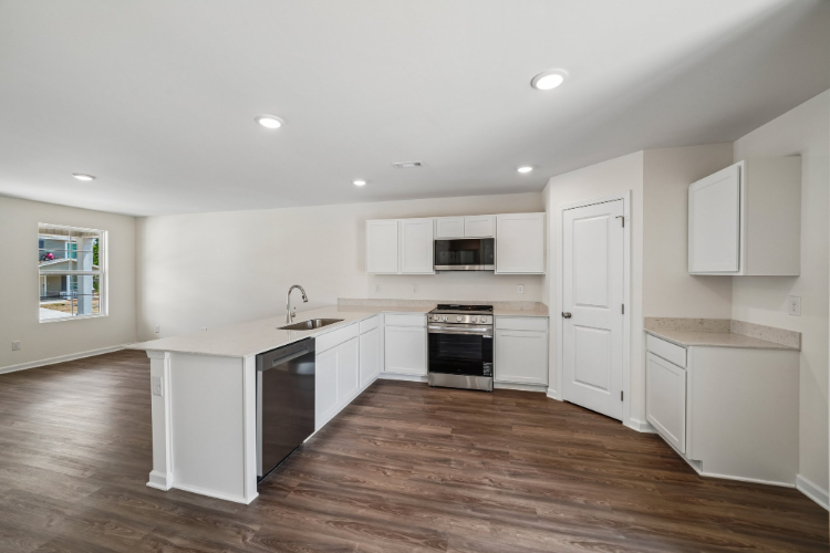 A kitchen with white cabinets.