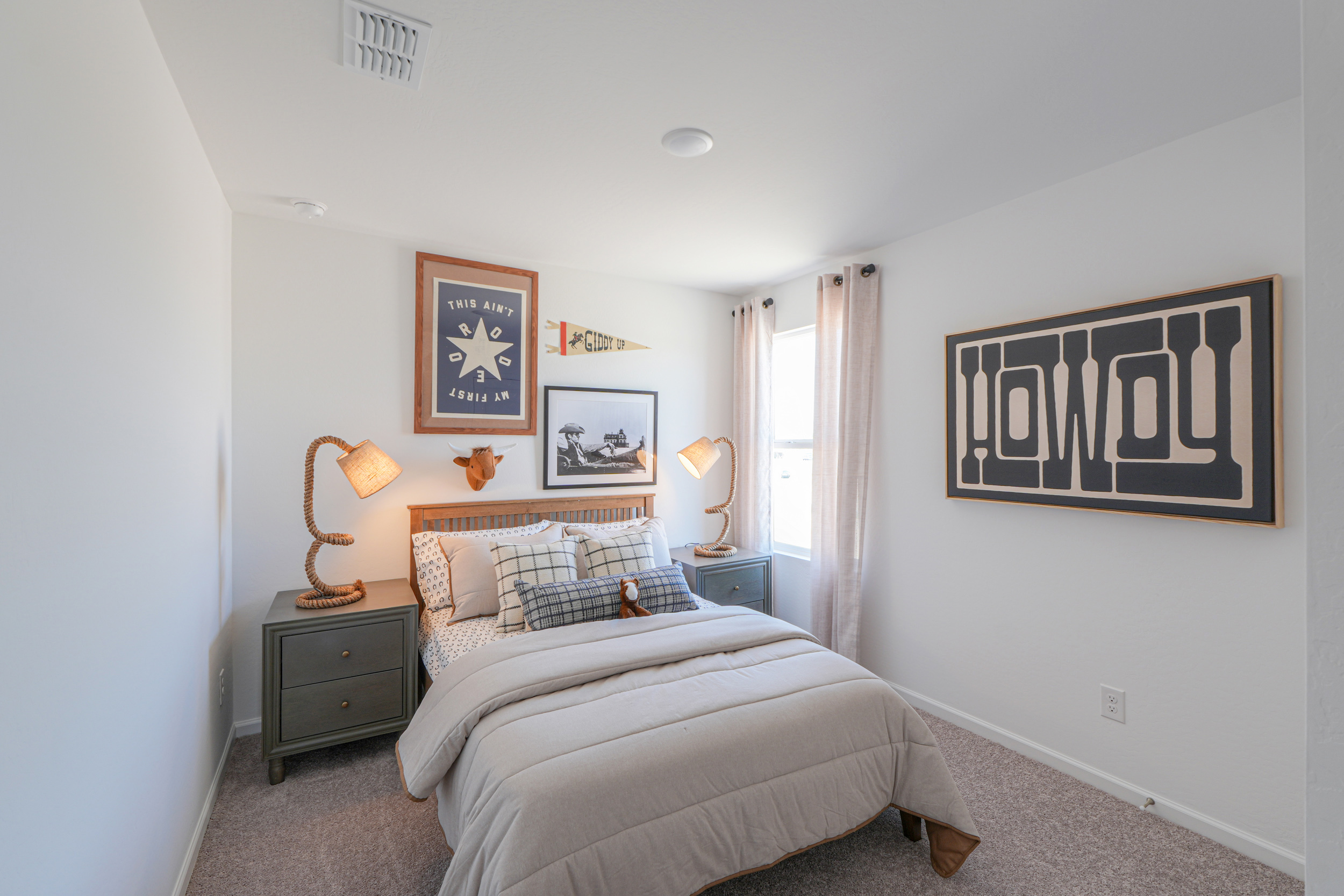 A bedroom with a bed and lamps.