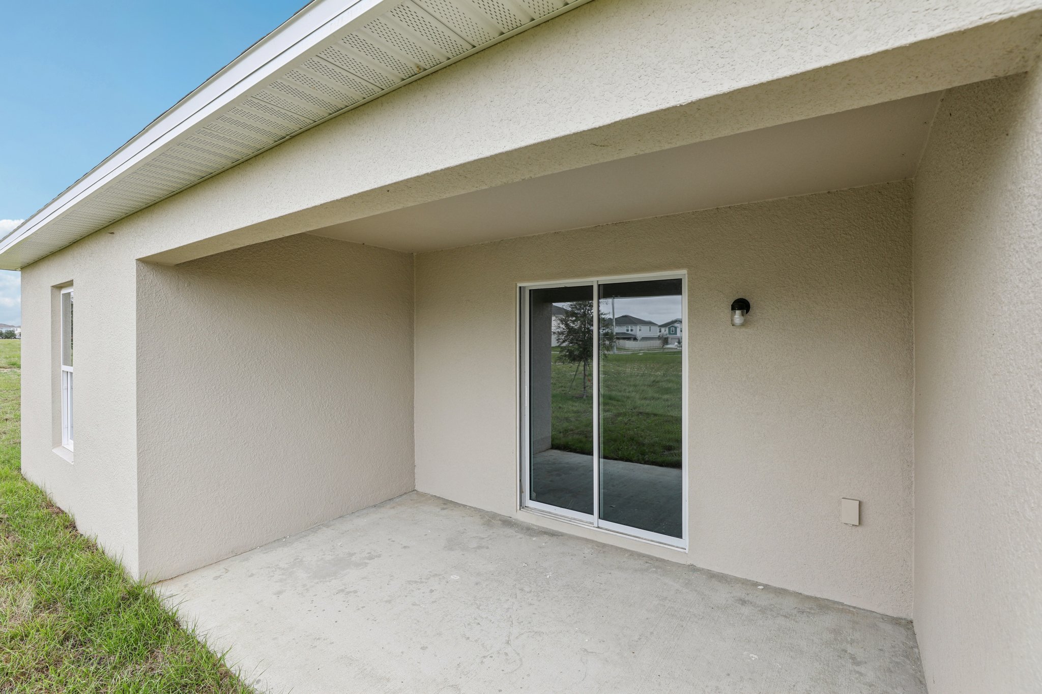 A white building with a glass door.