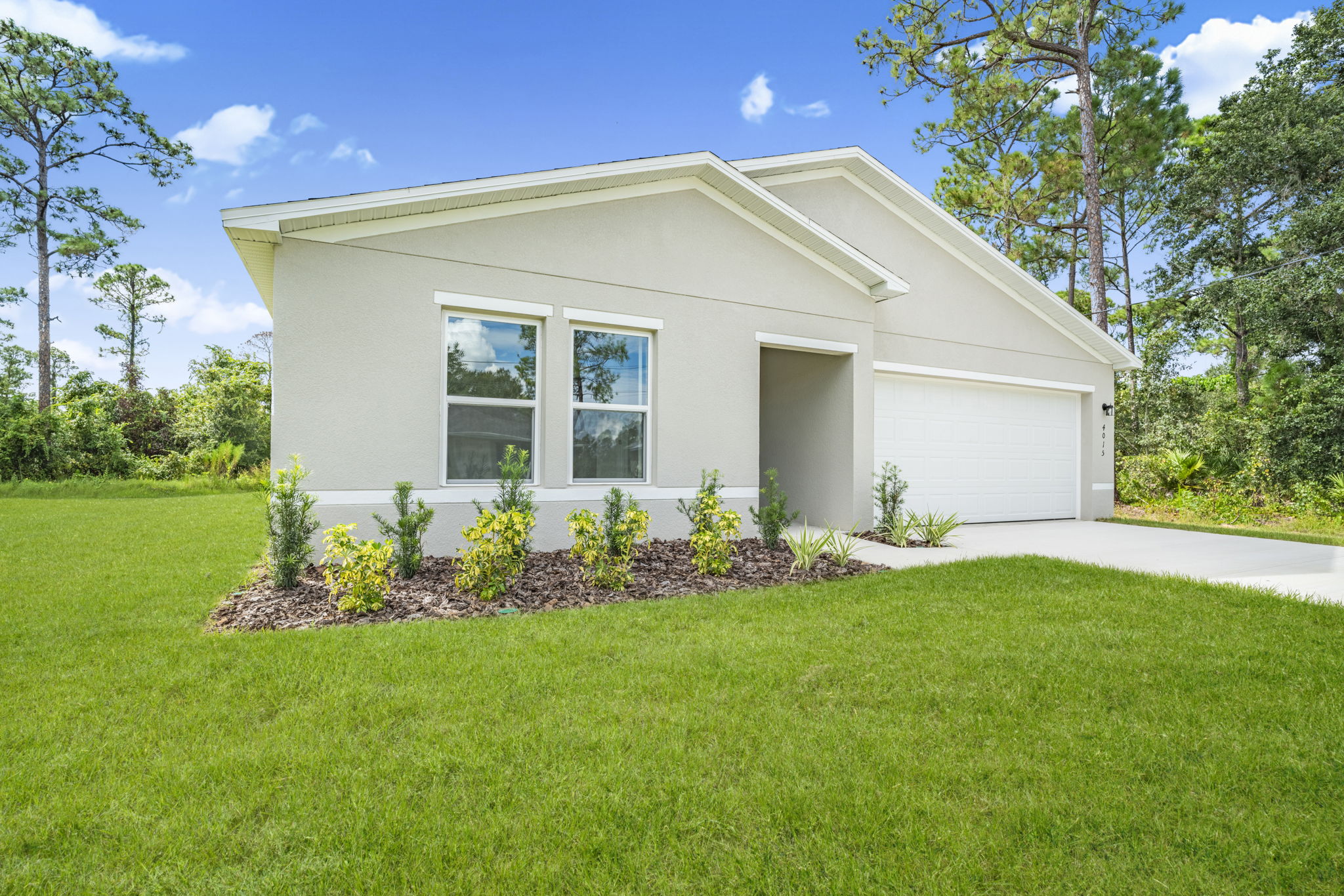 A house with a lawn and trees.