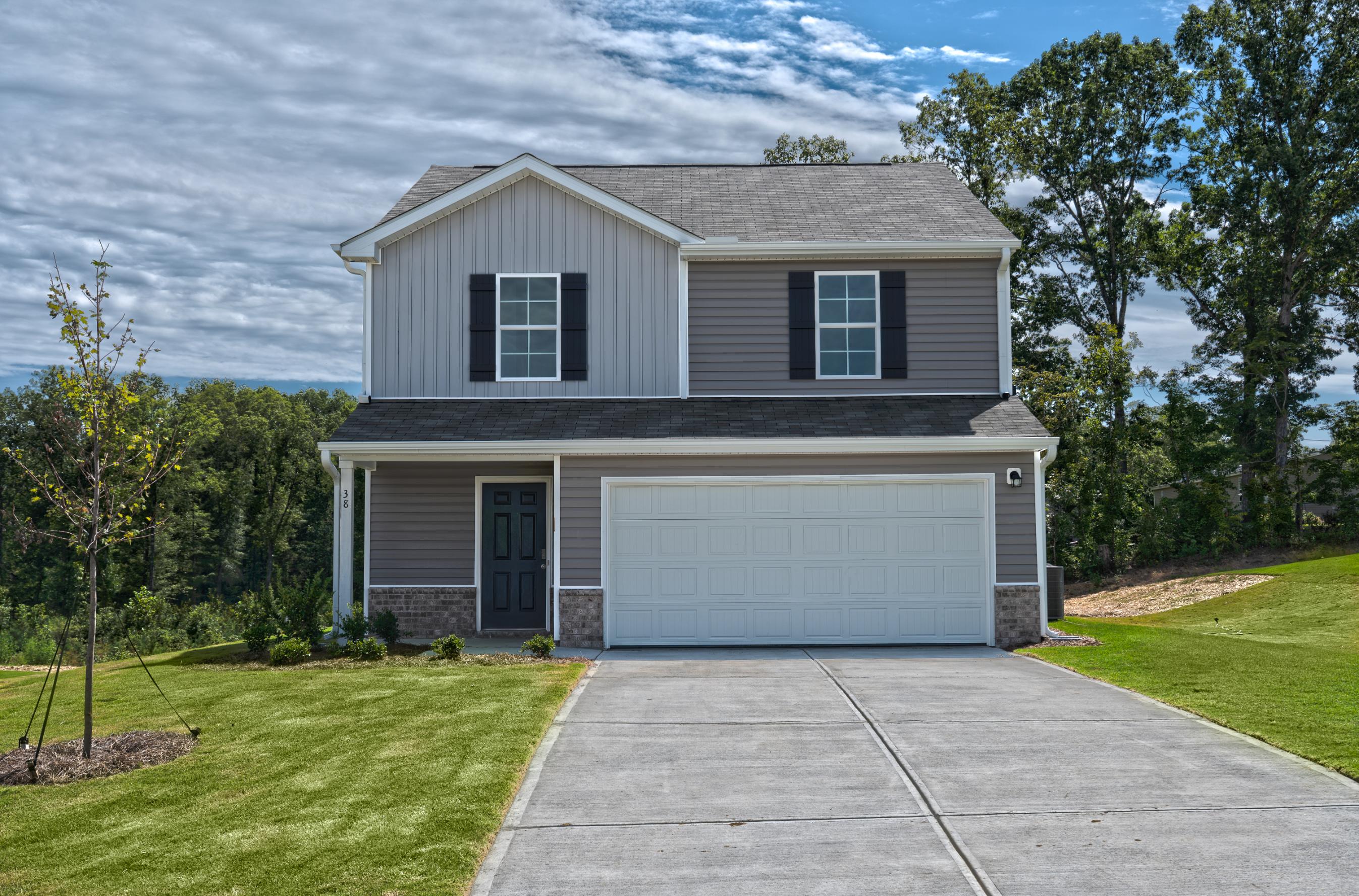 A house with a garage with Ronald Reagan Boyhood Home in the background.