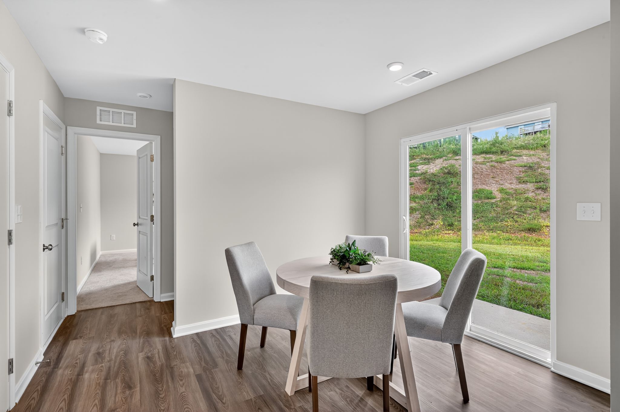 A dining room with a table and chairs.