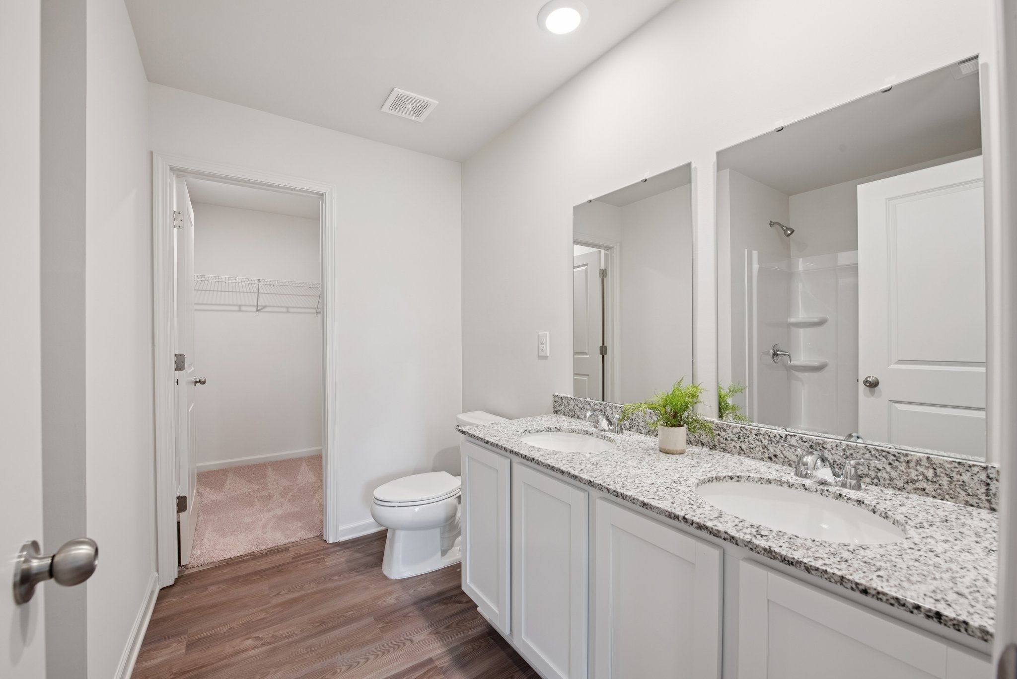 A bathroom with a large mirror.