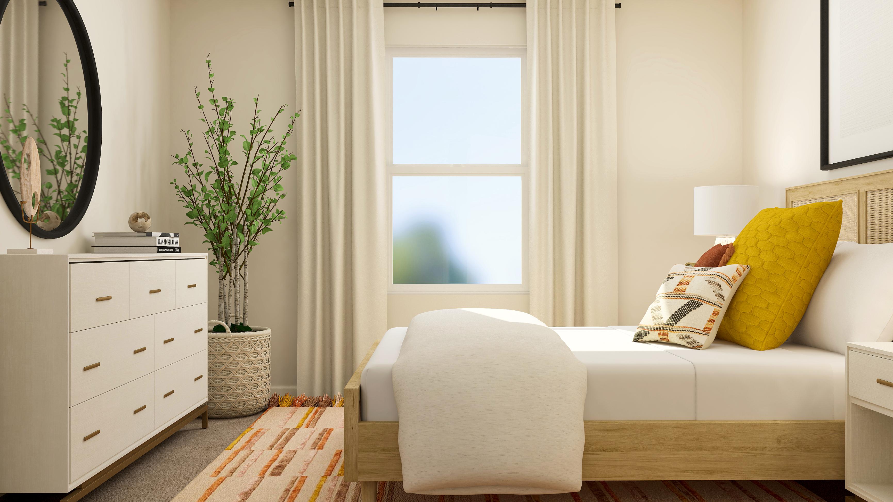 A white couch with a yellow pillow.