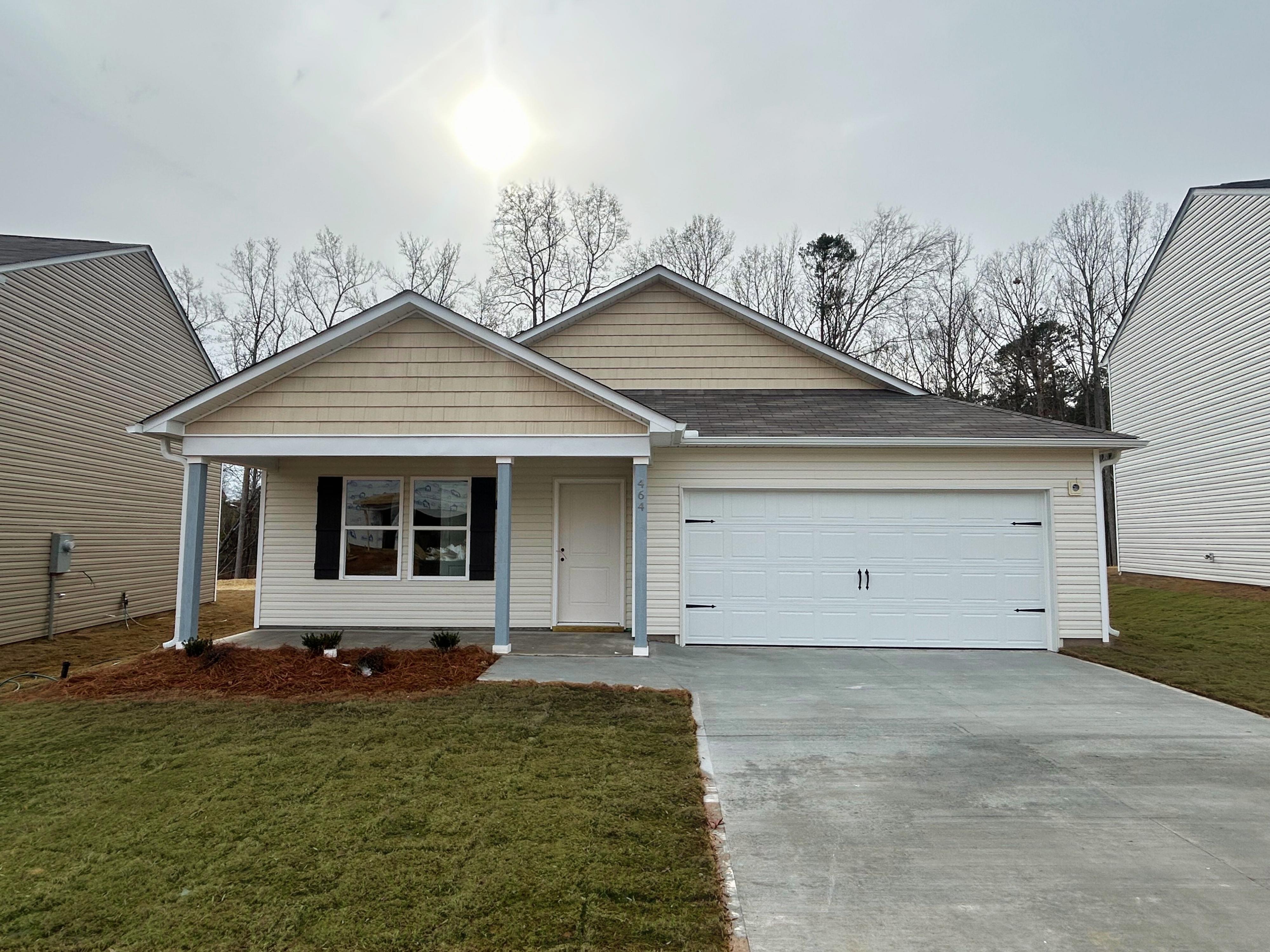 A house with garages and grass.