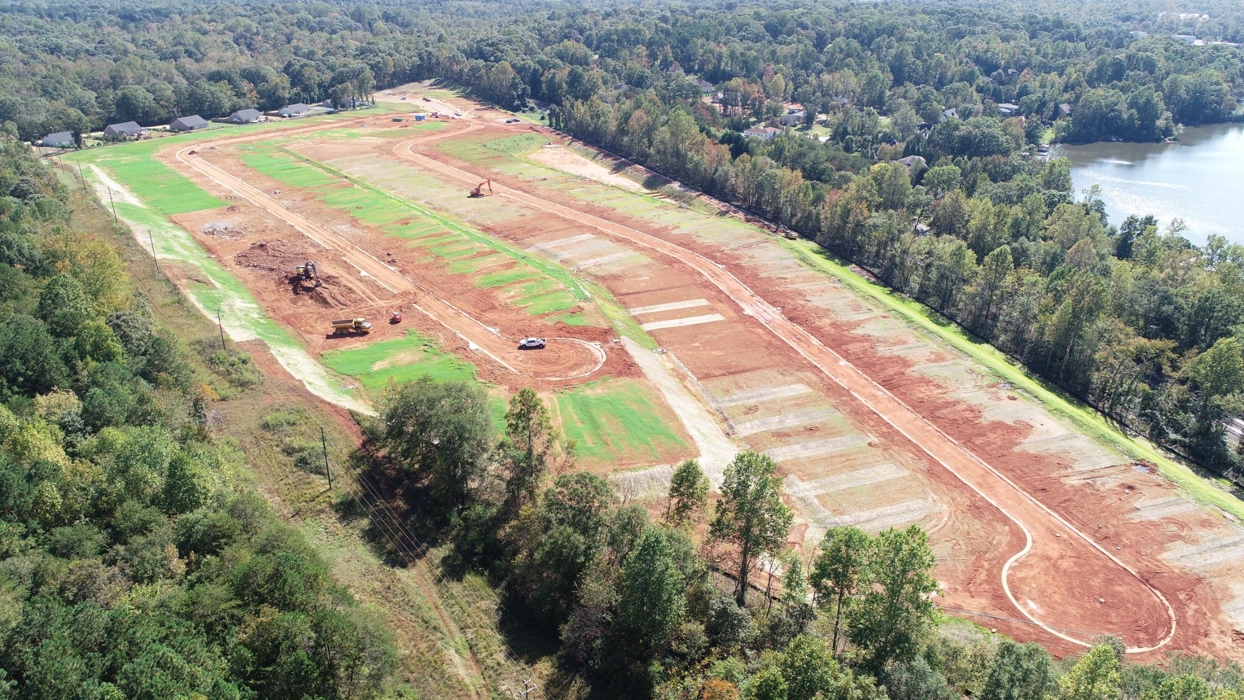 A road with trees and grass.