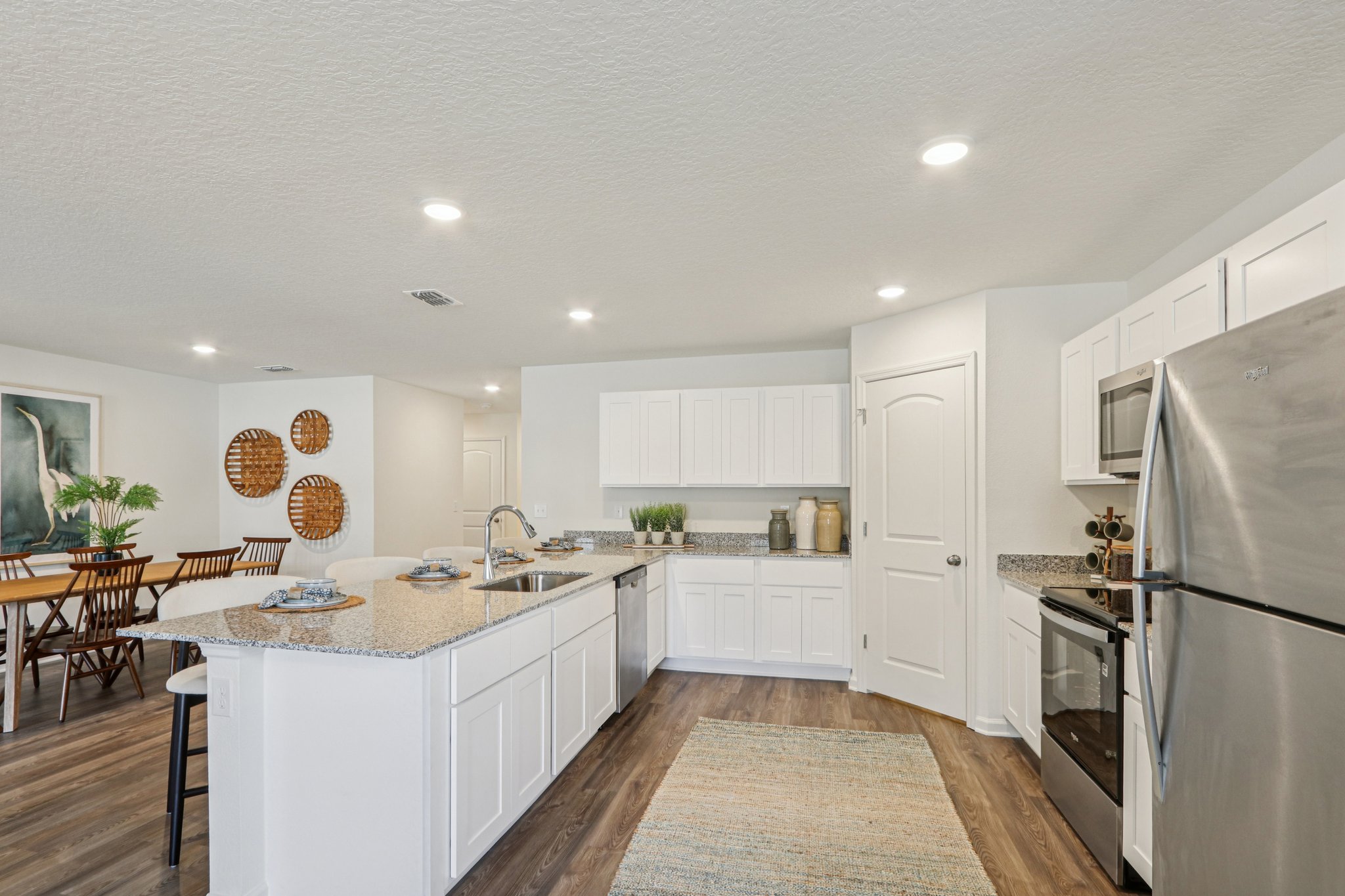 A kitchen with white cabinets.