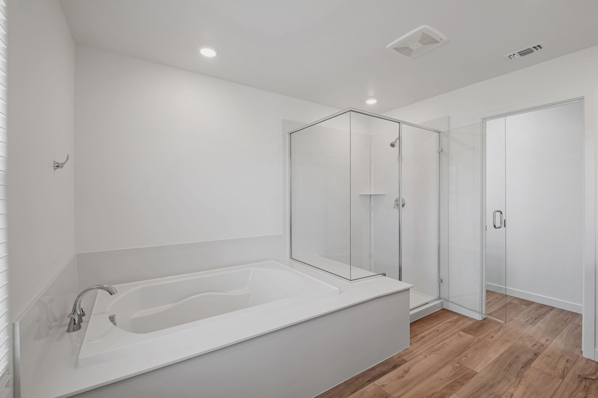 A bathroom with a tub and shower.