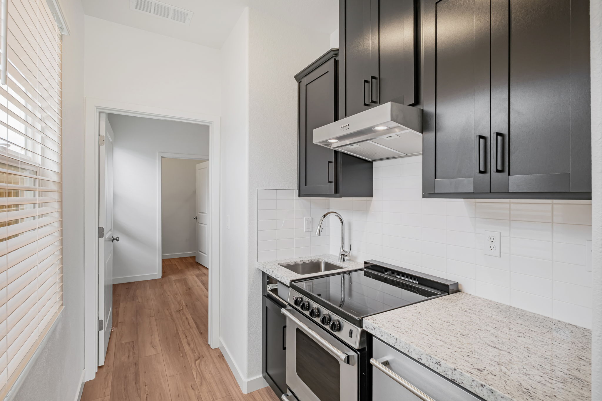 A kitchen with black cabinets.